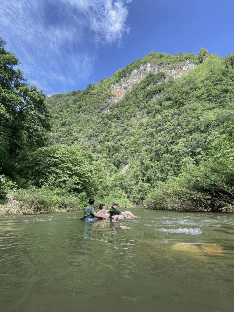 Khao Sok tubing adventure on Sok River with guests floating on swim tubes through jungle scenery and wildlife in Khao Sok National Park